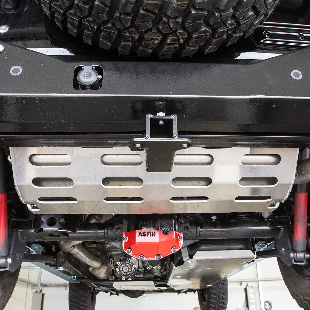ASFIR skid plate and red differential guard under a Toyota