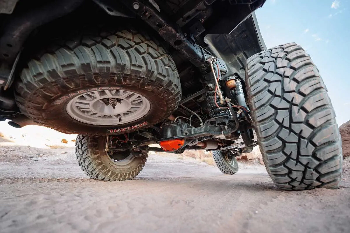 Toyota Gladiator flexing with ASFIR skid plates and red diff guard